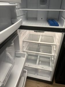 A spotless and empty refrigerator interior, thoroughly cleaned by Bee Clean Solutions in Lexington, KY.