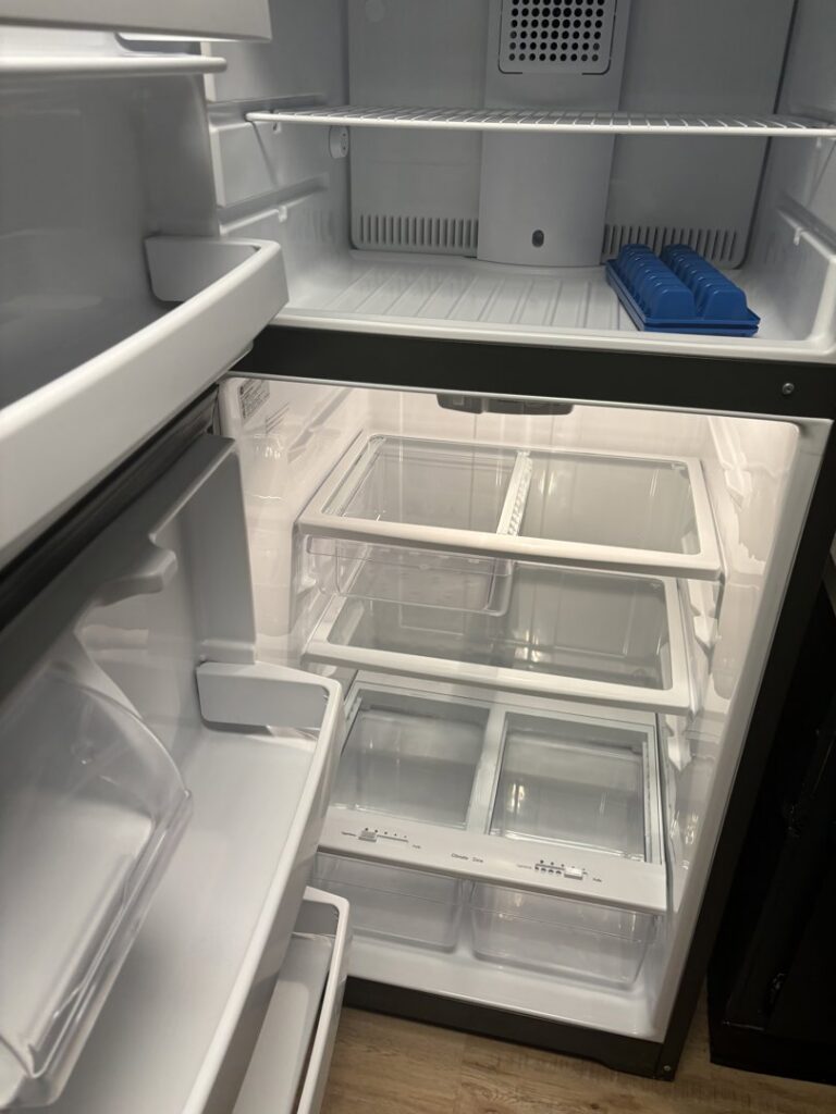 A spotless and empty refrigerator interior, thoroughly cleaned by Bee Clean Solutions in Lexington, KY.