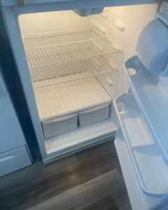 A sparkling clean and empty refrigerator interior, showcasing a service provided by Home Clean Home By Maria LLC in Aberdeen, SD.