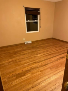 A clean, empty room with polished hardwood floors, ready for a new occupant, by Every Time Cleaning in Cedar Rapids, IA.