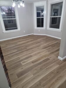 A clean, empty room with new flooring after professional house cleaning by Hm General Cleaning Services in Schenectady, NY