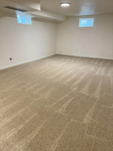 A clean, empty room with freshly vacuumed carpet, ready for new occupants by Dust Detail Cleaning Services in Post Falls, ID.