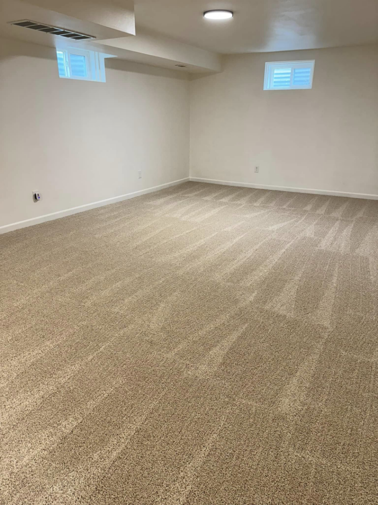 A clean, empty room with freshly vacuumed carpet, ready for new occupants by Dust Detail Cleaning Services in Post Falls, ID.