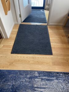A clean entryway floor with a welcome mat, showcasing professional house cleaning by Cuse Cleaning in Syracuse, NY.