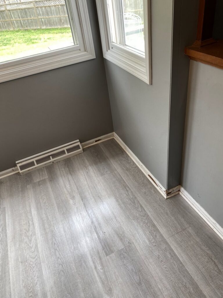 A clean floor and baseboards in a room, showcasing the meticulous cleaning services of Final Touch & More in Fort Wayne, IN
