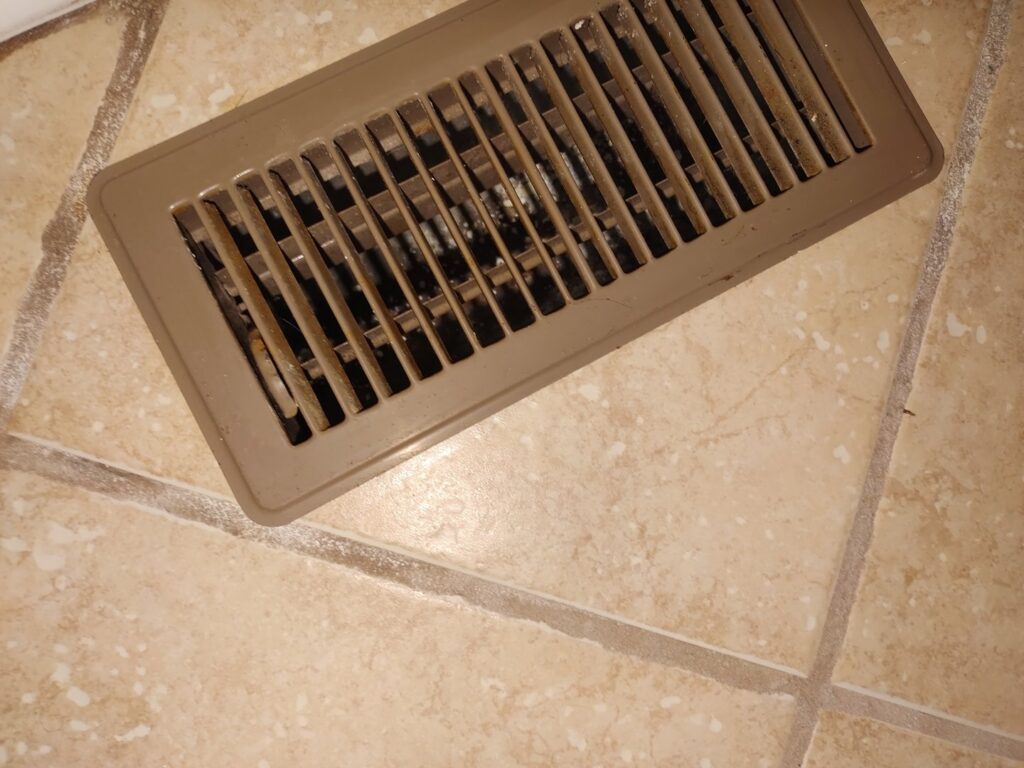 A clean floor vent on a tiled floor, showcasing the thorough cleaning service by Maid to Serve HIM in Cincinnati, OH.