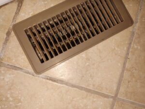 A clean floor vent on a tiled floor, showcasing the thorough cleaning service by Maid to Serve HIM in Cincinnati, OH.