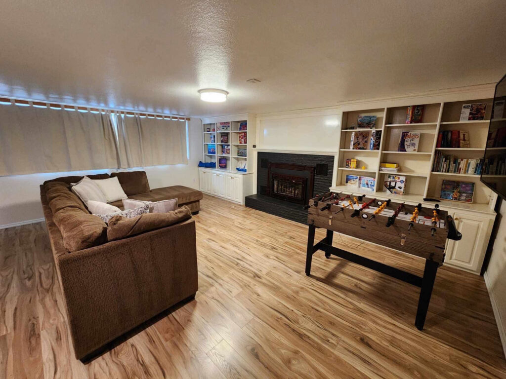A tidy game room with a foosball table and built-in shelves, showcasing the clean living spaces provided by E-N-S Home Cleaning Solutions, LLC in Lewiston, ID.