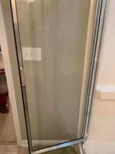 A sparkling clean glass shower door, showcasing the results of Quality Cleaning services in Summerville, SC.