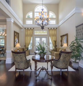 A clean and grand entryway with a beautiful staircase, maintained by Nooks and Crannies Cleaning Services in Norfolk, VA.