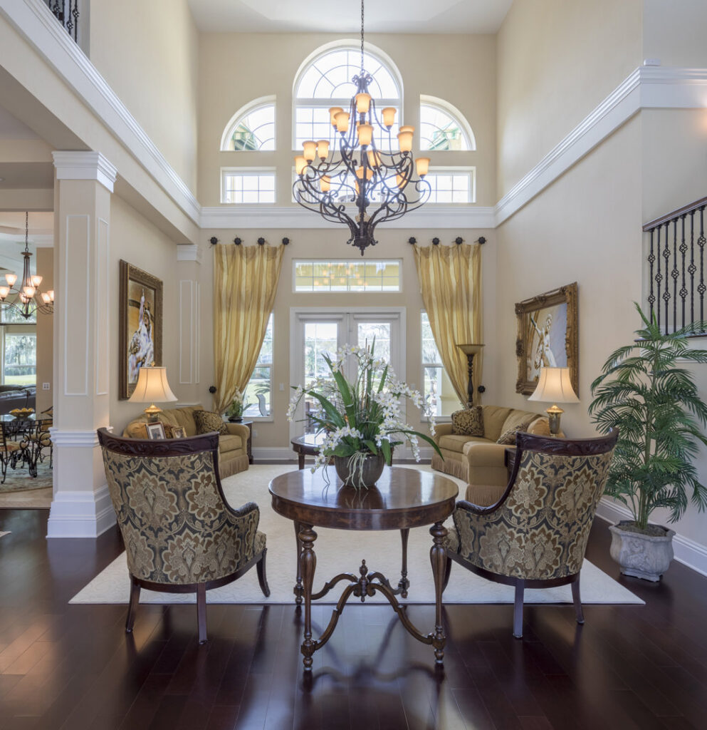 A clean and grand entryway with a beautiful staircase, maintained by Nooks and Crannies Cleaning Services in Norfolk, VA.
