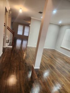 A spotless hallway and room with polished hardwood floors, showcasing the thorough cleaning by Rita's cleaning in Fort Worth, TX.