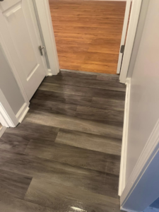 A clean hallway with shiny laminate flooring, reflecting the thorough cleaning services of The Clean Solution in Eagle Lake, TX