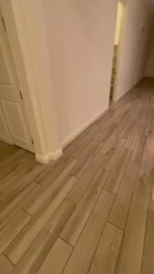 A clean hallway with polished wood-look tile flooring, showcasing the work of Picky Performance Cleaning in North Las Vegas, NV