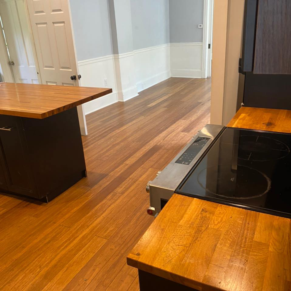 A sparkling clean kitchen and hallway with wooden floors, showcasing the results of Active Cleaning in Virginia Beach, VA