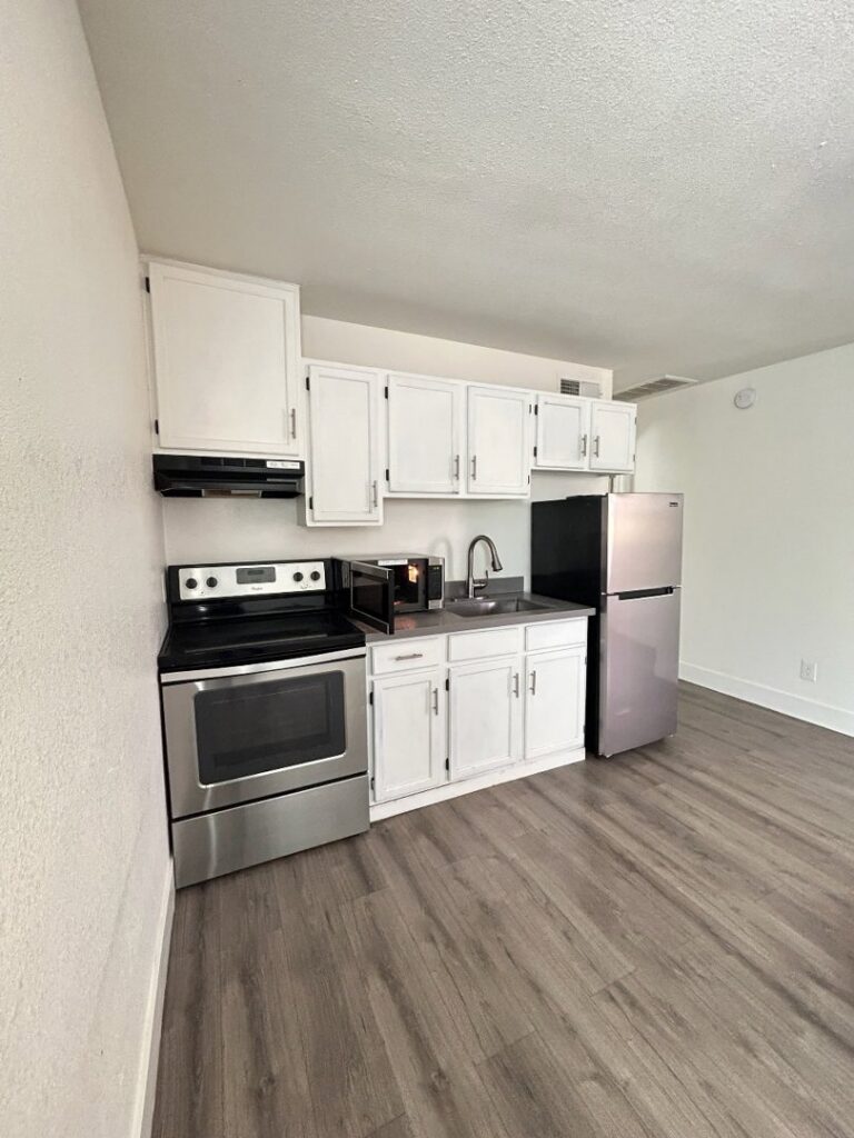 A spotless kitchen area featuring white cabinets and stainless steel appliances, professionally cleaned by Carole's House Cleaning in Tempe, AZ.