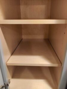 The clean and empty interior of a kitchen cabinet after professional cleaning by Rebeccas Customized Cleaning LLC in Reading, PA.