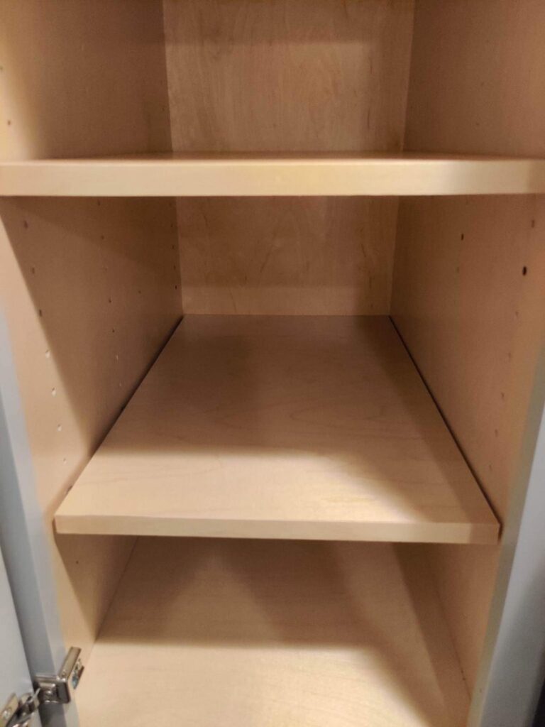 The clean and empty interior of a kitchen cabinet after professional cleaning by Rebeccas Customized Cleaning LLC in Reading, PA.