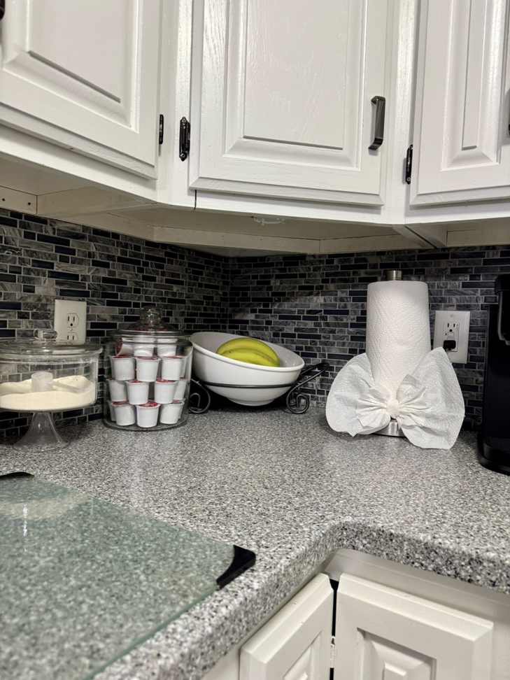 A sparkling clean kitchen countertop with organized items, showcasing the work of BNB Cleaning Pros in Hastings, NE.