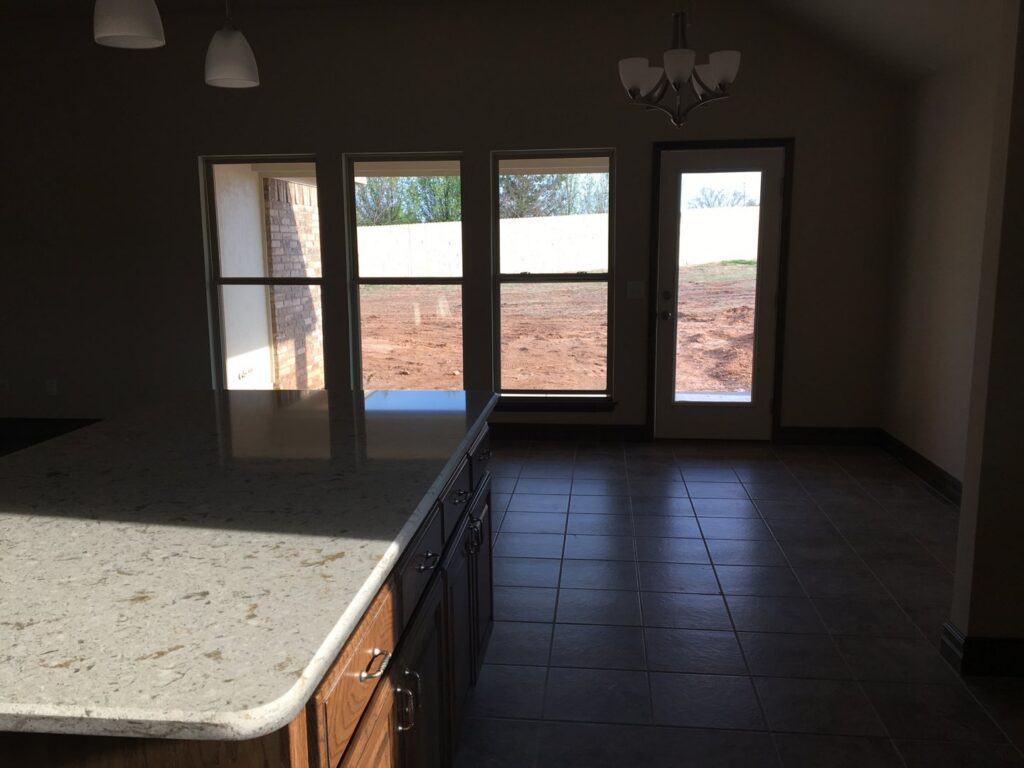 A bright and clean kitchen and dining area with tiled floors, professionally cleaned by Pristine Cleaning Concepts in Stillwater, OK.