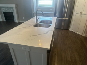 A spotless kitchen island with a double sink, demonstrating the cleaning quality of Sara's House Cleaning in Olathe, KS.