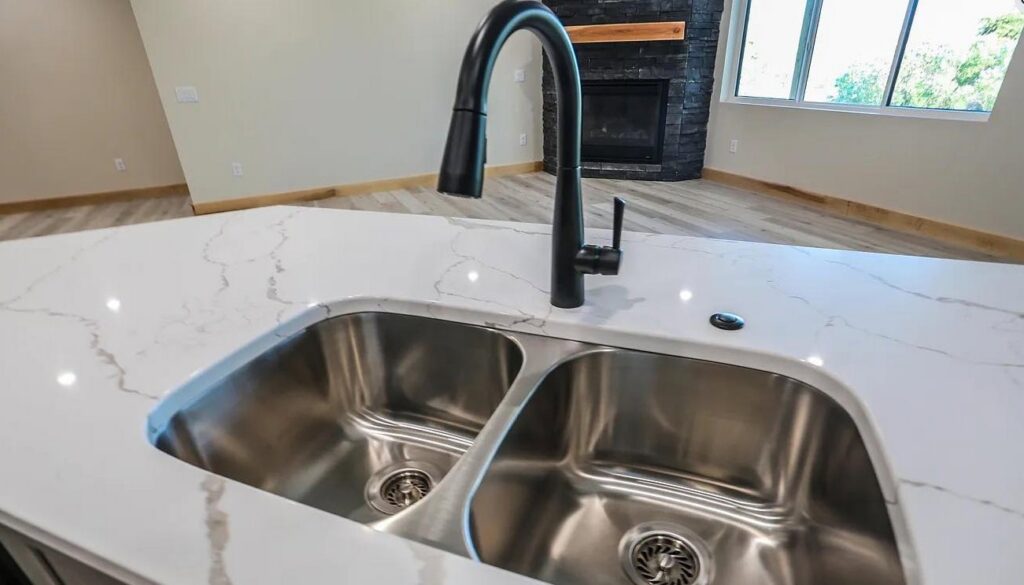 A clean kitchen island sink and faucet, demonstrating the meticulous cleaning services of Home Clean Home By Maria LLC in Aberdeen, SD.