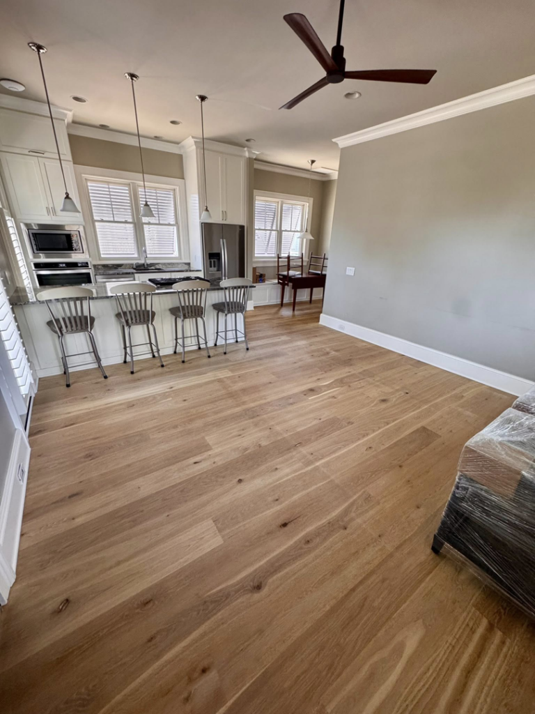 A sparkling clean kitchen and living room with polished hardwood floors by Affordable Cleaning in North Charleston, SC.