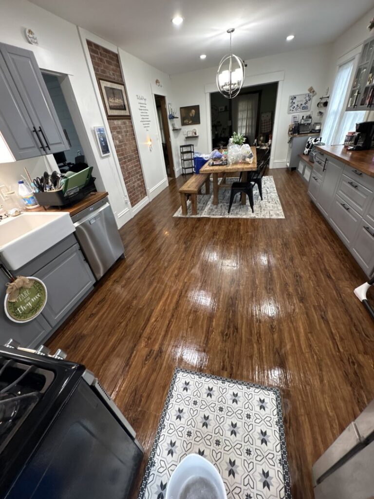 A beautifully cleaned kitchen with gleaming wooden floors, showcasing the results of Wilkie Wonders Cleaning in Akron, OH.