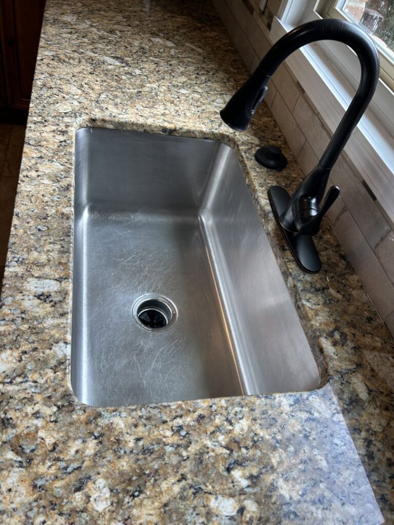 A sparkling clean kitchen sink after professional cleaning by Perfections Quality Cleaning Service in Dayton, OH.