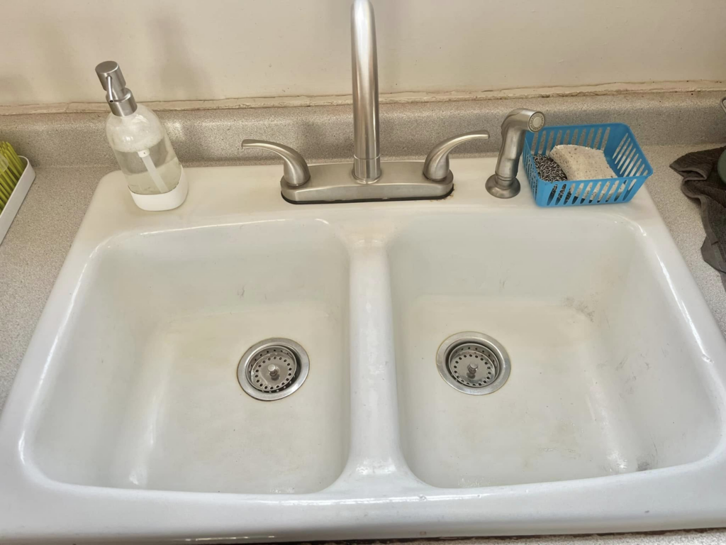 A spotless double kitchen sink after a thorough cleaning by Lorena Lyons Cleaning in Concord, NH.