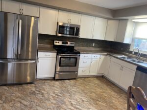 A modern, clean kitchen with stainless steel appliances and white cabinets, reflecting the quality cleaning of Final Touch & More in Fort Wayne, IN