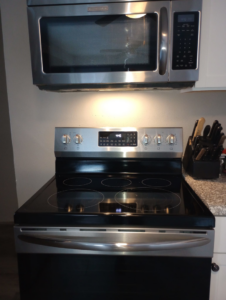 A sparkling clean kitchen stove and microwave after professional cleaning by Ms. Maid by Lynae in Janesville, WI.