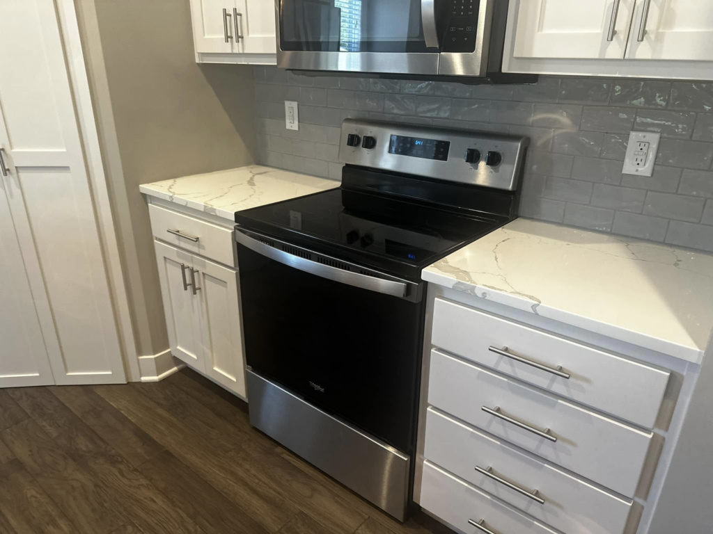 A pristine kitchen featuring a clean stove and microwave, cleaned by Sara's House Cleaning in Olathe, KS.