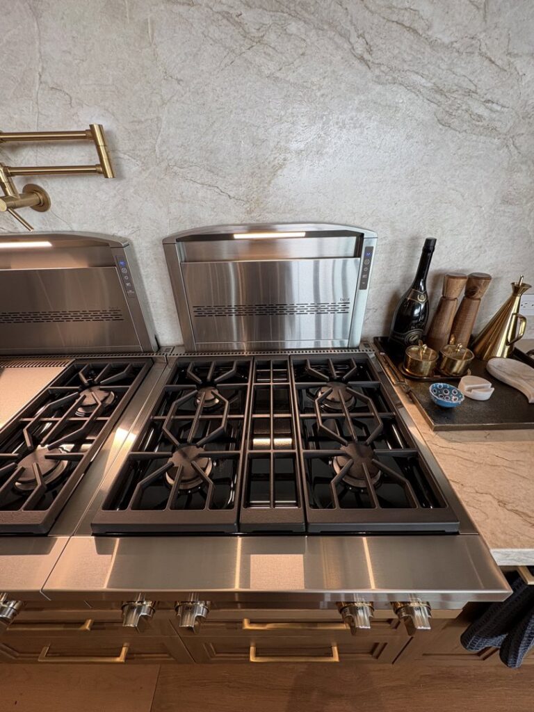 A sparkling clean kitchen stovetop and stainless steel range hood, reflecting Kleen Slate's meticulous cleaning in Shakopee, MN.