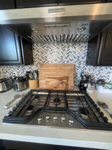 A sparkling clean kitchen stovetop and range hood after a professional cleaning by Picky Performance Cleaning in North Las Vegas, NV