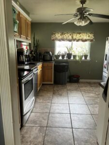 A sparkling clean kitchen with a mop and bucket in the corner, showcasing the results of Jades Cleaning Solutions LLC in Stillwater, OK.