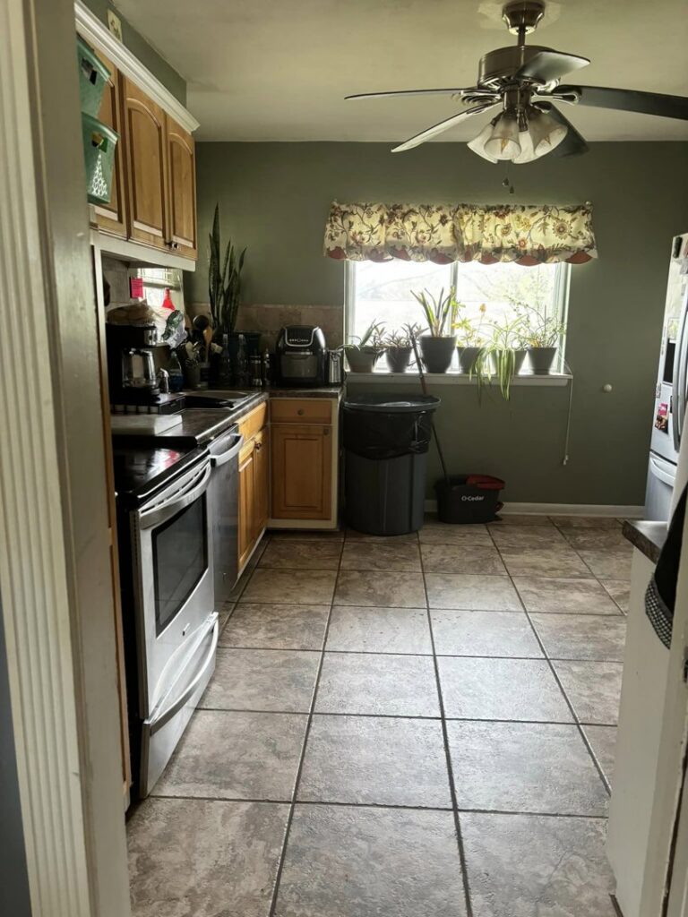 A sparkling clean kitchen with a mop and bucket in the corner, showcasing the results of Jades Cleaning Solutions LLC in Stillwater, OK.