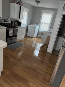A clean kitchen featuring gleaming hardwood floors and stainless steel appliances, showcasing Make It Shine in Worcester, MA
