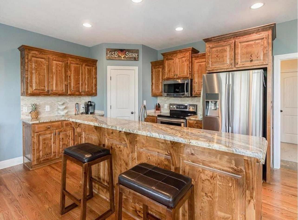 A sparkling clean kitchen with wooden cabinets and granite countertops by Expert Cleaning On Demand in Tonganoxie, KS.