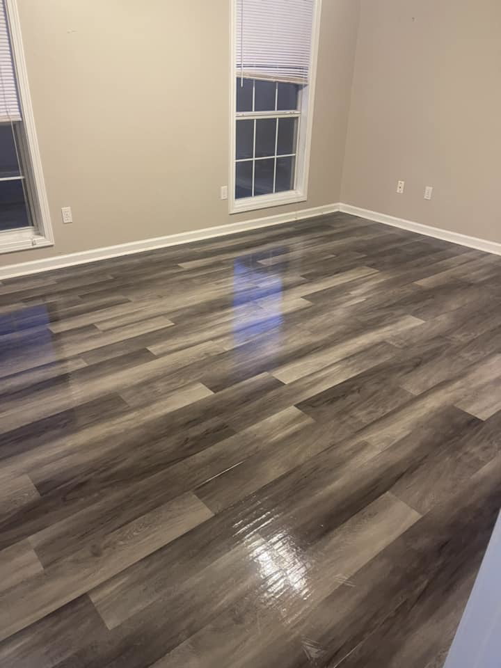A freshly cleaned laminate floor in a bedroom, showcasing the results of The Clean Solution's work in Eagle Lake, TX