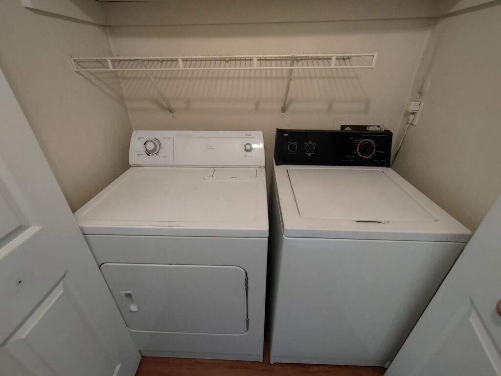 A clean laundry area with a white washer and dryer, part of the comprehensive cleaning by Tessa's Cleaning Service in Chesapeake, VA.