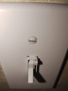 A clean white light switch, highlighting the thoroughness of house cleaning services by Maid to Serve HIM in Cincinnati, OH.