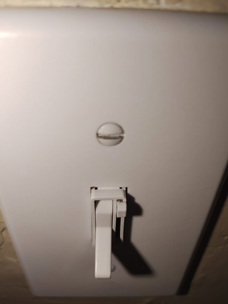 A clean white light switch, highlighting the thoroughness of house cleaning services by Maid to Serve HIM in Cincinnati, OH.