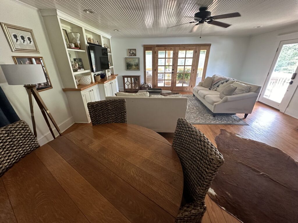 A spacious and clean open-plan living and dining area with hardwood floors, tidied by Top-Notch Tidy Services in Chesapeake, VA.