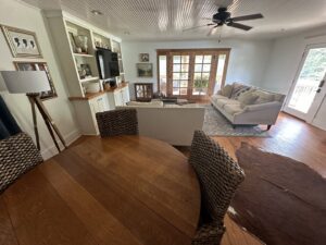 A spacious and clean open-plan living and dining area with hardwood floors, tidied by Top-Notch Tidy Services in Chesapeake, VA.
