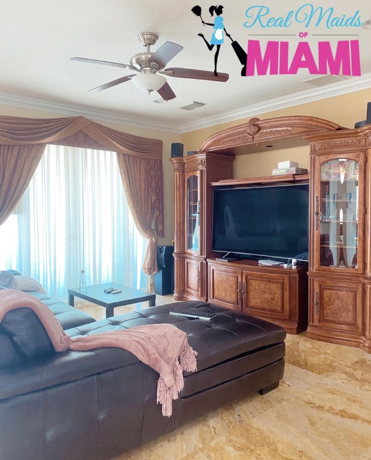 A clean living room with a large entertainment center, tidied by Real Maids of Miami, LLC in Miami, FL.