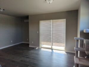A sparkling clean living room with hardwood floors, showcasing the quality house cleaning by Columbia Cleaners in Columbia, MO.