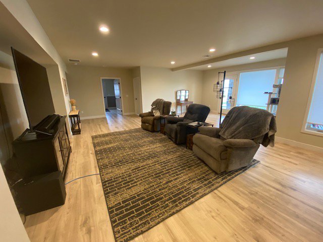 A spacious and clean living room with comfortable recliners and a large rug, maintained by E-N-S Home Cleaning Solutions, LLC in Lewiston, ID.