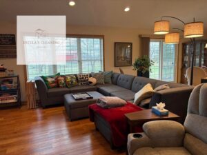A neat and clean living room with a large sectional sofa, reflecting the excellent house cleaning services from Estela's Cleaning Service's in Lake Elmo, MN.