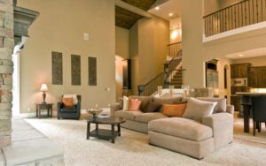 A clean and inviting living room with a comfortable sofa and ottoman, maintained by Nooks and Crannies Cleaning Services in Norfolk, VA.